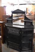 A Victorian aesthetic period ebonized wood credenza, of architectural form decorated with panels