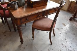 Victorian mahogany writing table with rounded front corners, moulded edge and two drawers, raised on