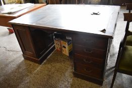 An early 20th century mahogany pedestal partners desk, of traditional arrangement with banks of