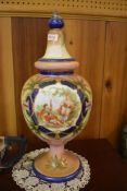 A continental painted glass urn, decorated with figural vignette and foliage. 48CM.