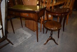 A reproduction serpentine fronted mahogany side table with inset gilt tooled leather surface ,
