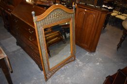 A modern woven wicker mirror having arched surmount. 125CM.
