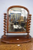 A Victorian mahogany swing dressing mirror with barley twist support and rounded oblong platform.
