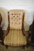 A Victorian mahogany easychair having a deep buttoned padded back between short fluted and