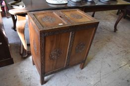 A 20th century Chinese carved hardwood cabinet, of rectangular form the top with double hinged doors