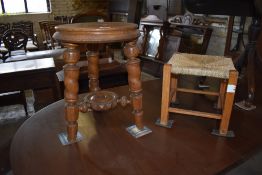 A Victorian oak piano stool, of circular form with turned legs linked by a circular under tier 46CM.