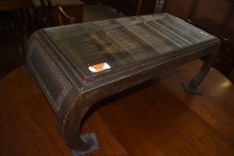 A Chinese carved and stained hardwood coffee table, of oblong form with carved chinoiserie scene, on