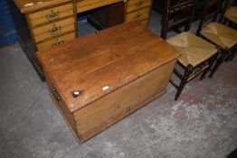 A 19th century pine bedding box of rectangular form, with hinged cover over two base drawers.
