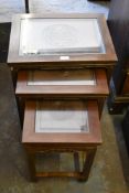 A nest of three Chinese hardwood tables. decorated with moulded roundel design. Largest 56CM.