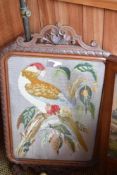 A Victorian mahogany pole screen, the embroidered rectangular panel depicting a perched parrot,