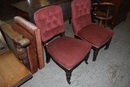 Two Victorian mahogany upholstered salon chairs, having deep buttoned backs, raised on turned and