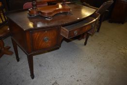 An Edwardian mahogany bow fronted sideboard with reeded edge detail over three cockbeaded drawers