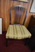 A George III mahogany dining chair, the hooped back with shaped and pierced vase form splat over the