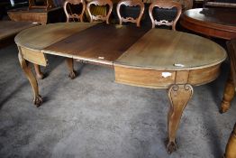An early 20th century mahogany extending dining table, the D shaped ends with moulded detail over