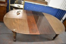 Victorian mahogany extending dining table, the D shaped ends enclosing two leaves and raised on