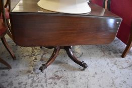 A Victorian mahogany pedestal Pembroke table, of oblong form with rounded flaps, raised on turned