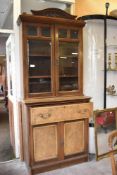 A late Victorian walnut secretaire bookcase, having stippled carved surmount and bevelled glazed