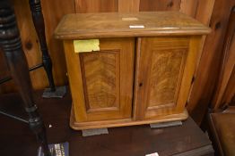 A Victorian figured walnut table cabinet, the panelled doors opening to reveal the now vacant