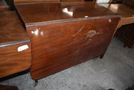 An early 19th century mahogany dropleaf table, with rounded rectangular flaps, all raised on gated
