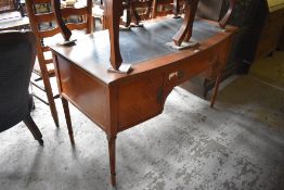 A Reproduction mahogany bow fronted writing desk with single central drawer flanked by cupboards,