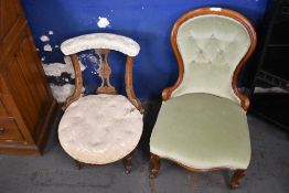 A late Victorian mahogany nursing chair with incised decoration and deep buttoned upholstery, sold