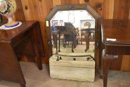 An early 20th century oak framed and bevelled rectangular mirror with canted and moulded design.