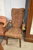 Victorian upholstered captains type armchair, with burgundy floral upholstery, turned supports and