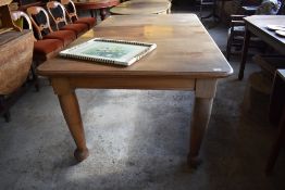 A late 19th/ early 20th century mahogany extended dining table, having moulded edge detail over
