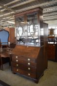 A George III astragal glazed oak bureau bookcase, of traditional design, the glazed top appears to