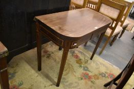 A 19th century mahogany fold over tea table, of rounded rectangular form with tablet freize and