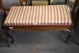 A continental design mahogany padded double Stool, with hinged seat enclosing storage. 53CM. X.