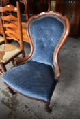 A Victorian mahogany spoonback nursing chair of traditional design. Seat height. 38CM.