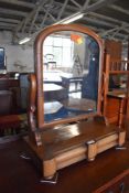 A Victorian figured walnut swing dressing mirror. 66CM.
