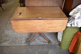 A 19th century mahogany pedestal Pembroke table, the four down swept legs finishing with brass