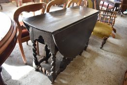 A 19th century stained oak drop leaf dining table with turned barley twist supports 76CM X. 122CM.