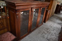 A large Victorian glazed mahogany bookcase top, having a moulded cornice over carved pendant and
