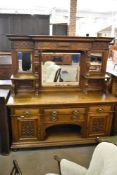 A large Victorian oak mirror back sideboard, the raised mirror back of breakfront form with