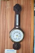 The 20th century aneroid barometer, having rudimentary carving and enameled dial. 76CM