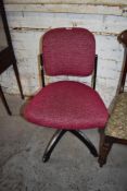 A mid century metal framed office or machinists chair, later upholstered in pink material, having