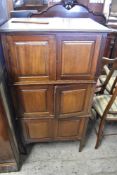 An Edwardian Mahogany three stage cupboard, each stage with panelled doors between fluted ends.