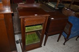 An Edwardian glazed music cabinet of traditional design sold together with an Edwardian mahogany