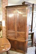 A George III Mahogany double corner cupboard, the cornice with bead moulding and repeating stipple