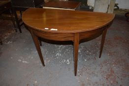 A 20th century mahogany D shaped table, raised on tapering square, section legs, Retaining table
