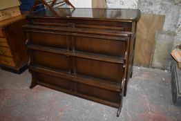 An Ercol dark elm dresser, bearing label to lower left door. 160CM. X. 123CM.