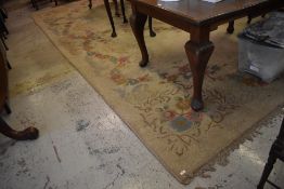 A large floral patterned machined room carpet, patches of moth damage throughout some losses to