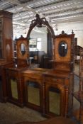 A Victorian inlaid mahogany mirror back sideboard the central arched and bevelled plate with foliate