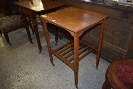 An Edwardian Arts and Crafts oak occasional table, with slatted under tier and casters. 76CM.