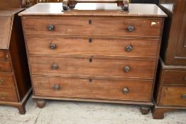 A 19th century mahogany chest of four long cockbeaded drawers, each with turned knob handles and
