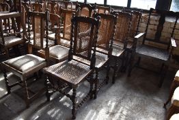 A group of nine oak cane backed barley twist chairs.