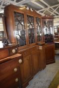 A 'Cresta' reproduction mahogany astragal glazed bookcase, with broken swan neck pediment over three